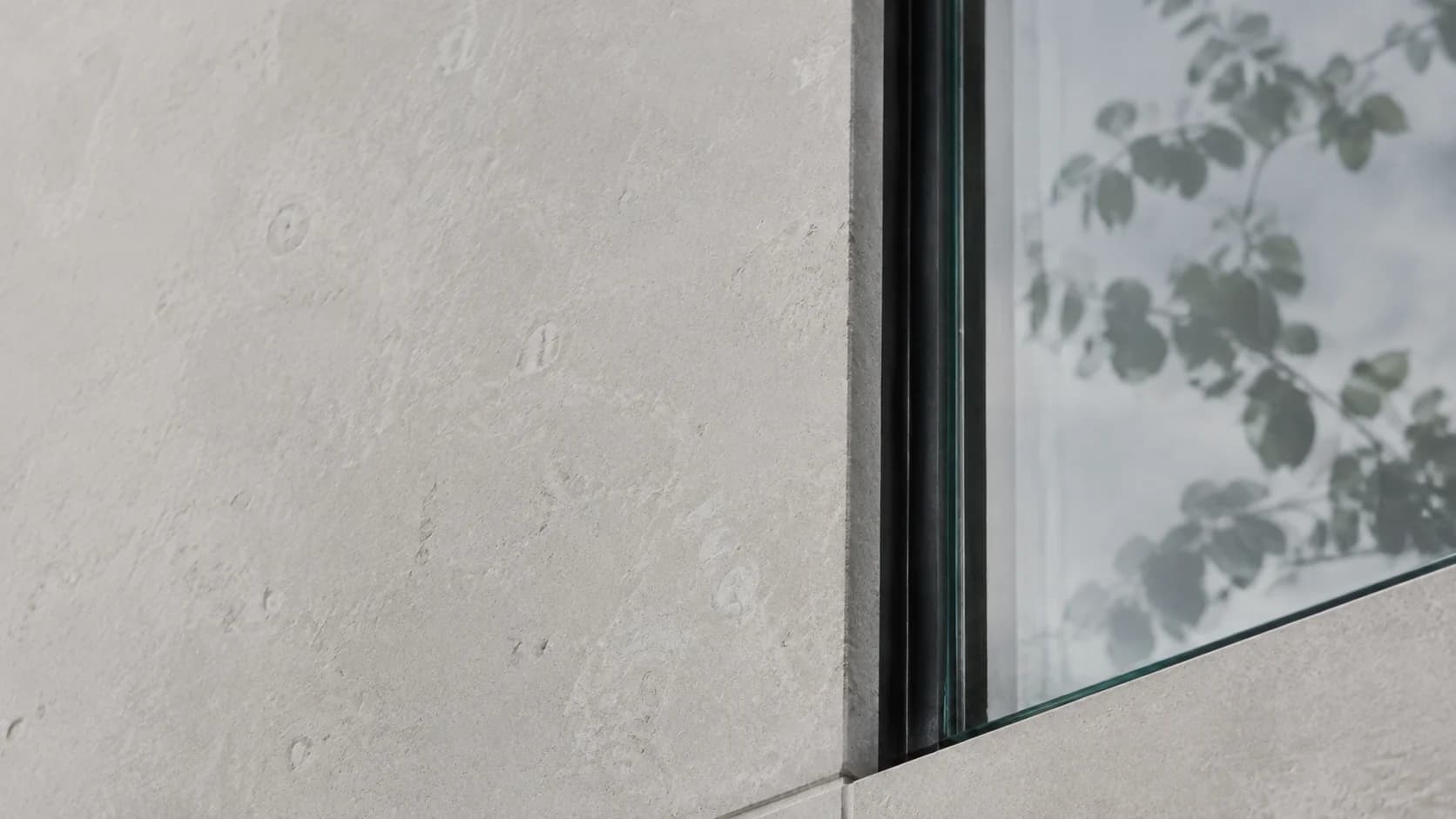 Detail of limestone and shaded architectural glass
