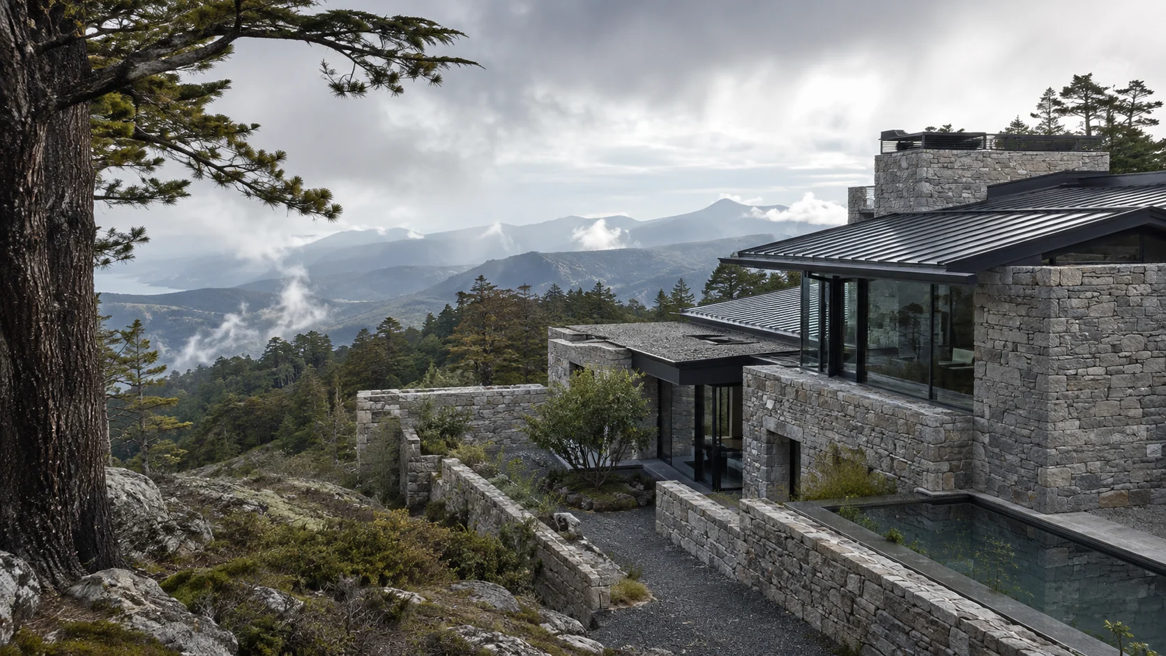 A stone mountain house set among cedar trees
